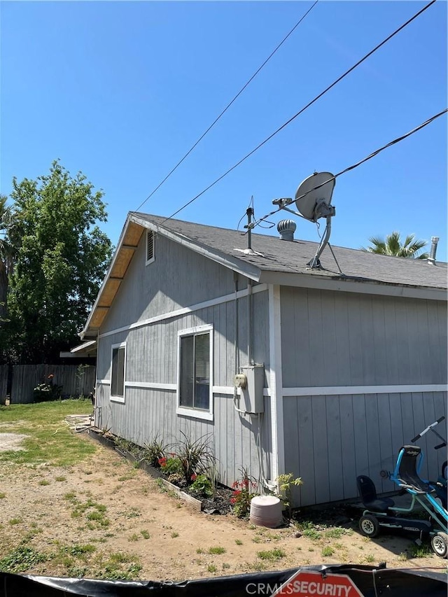 view of home's exterior with fence