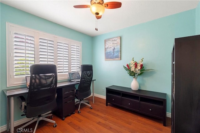 home office with ceiling fan, baseboards, and wood finished floors