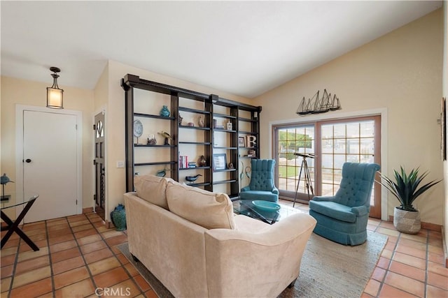 sitting room featuring tile patterned floors and vaulted ceiling