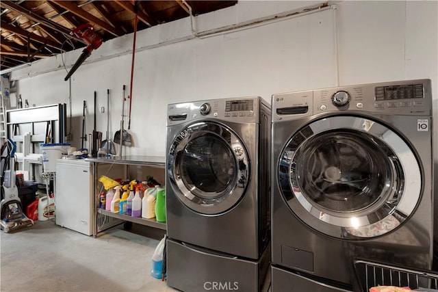 washroom with washing machine and clothes dryer and laundry area