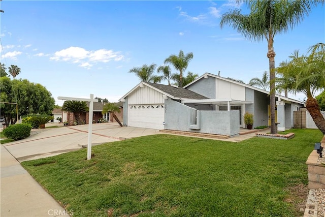 view of front facade with a front lawn, driveway, stucco siding, and a garage