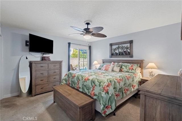 bedroom with carpet, a textured ceiling, baseboards, and ceiling fan