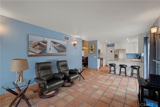 living area with light tile patterned floors, recessed lighting, and visible vents