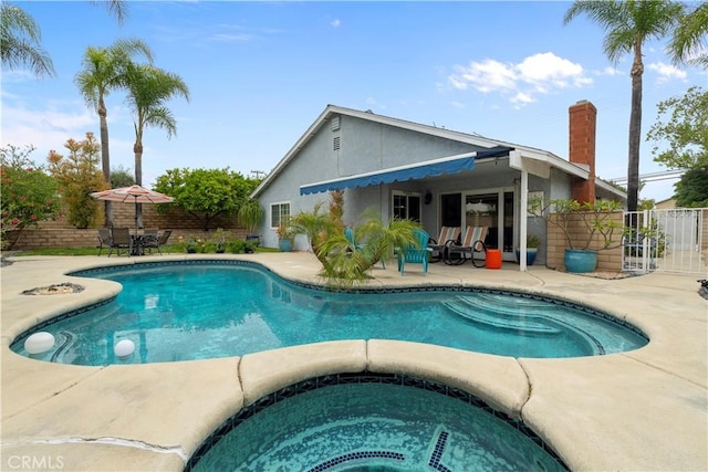 view of swimming pool with a patio area, an in ground hot tub, fence, and a fenced in pool