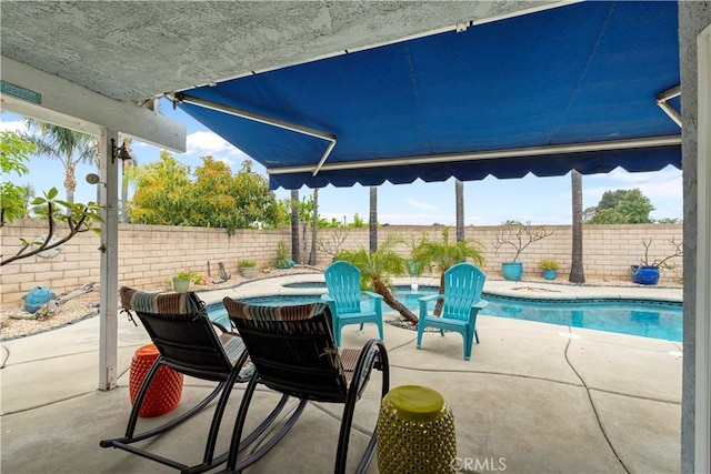 view of patio with a hot tub, a fenced backyard, and a fenced in pool