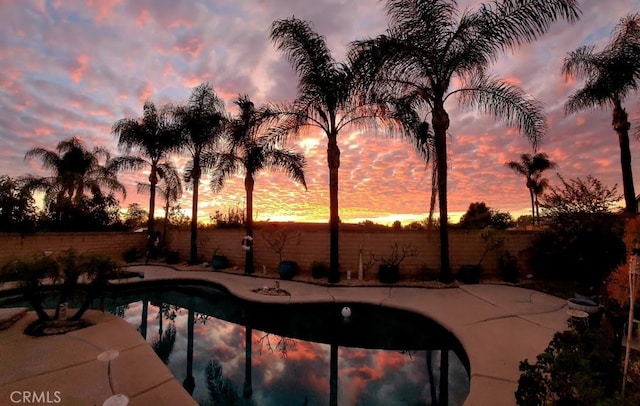 outdoor pool featuring fence and a patio area