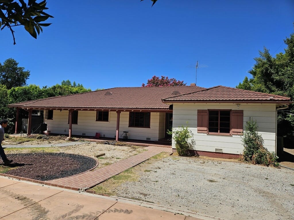 view of front of house with a tiled roof and crawl space