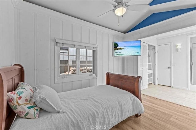 bedroom featuring a ceiling fan, vaulted ceiling, and wood finished floors