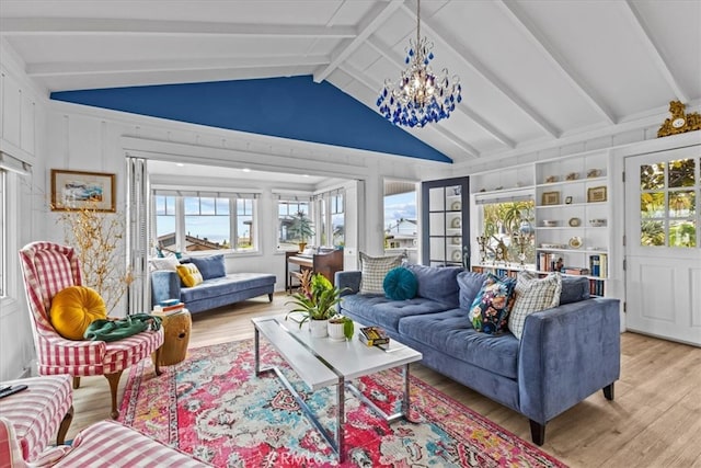 living room with a wealth of natural light, a notable chandelier, vaulted ceiling with beams, and wood finished floors