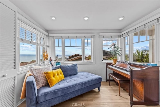 sunroom / solarium featuring recessed lighting, baseboards, and wood finished floors