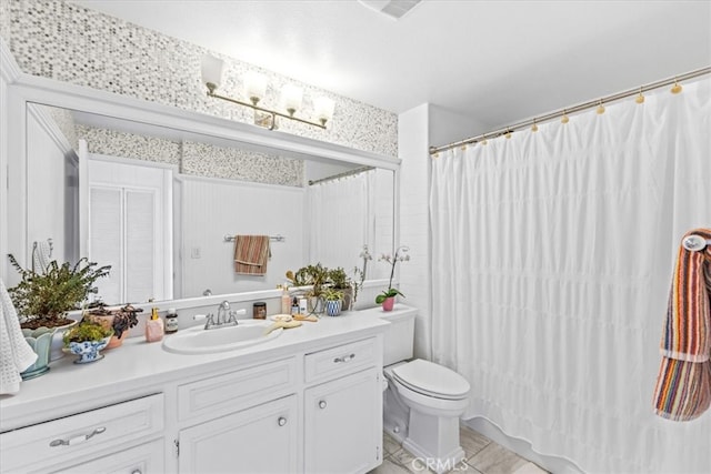 bathroom with vanity, toilet, a shower with curtain, and tile patterned flooring