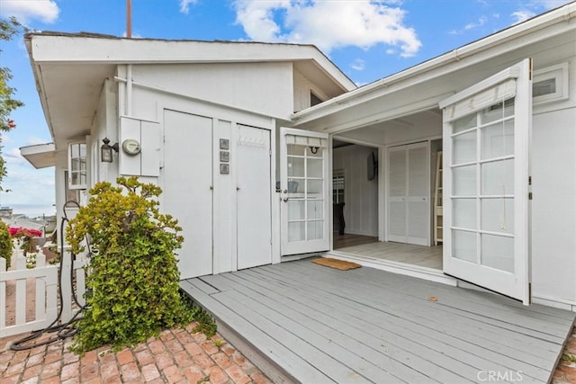 view of exterior entry featuring a wooden deck