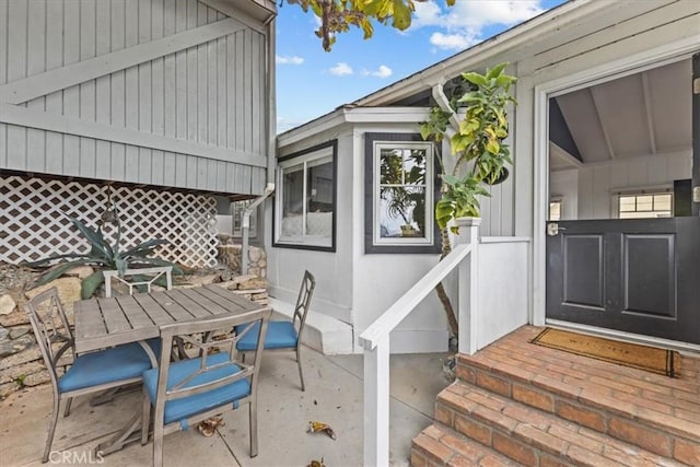 view of exterior entry with a patio area and outdoor dining space