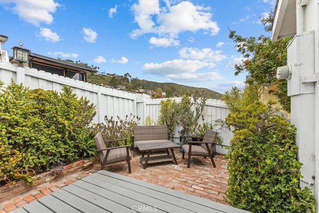 wooden terrace featuring a patio and fence