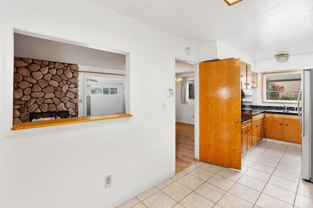 6552 Mallard St, San Diego, CA 92114 - kitchen with plenty of natural light, freestanding refrigerator, dark countertops, and light tile patterned flooring