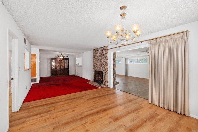 6552 Mallard St, San Diego, CA 92114 - unfurnished living room with ceiling fan, a textured ceiling, wood finished floors, a chandelier, and a fireplace