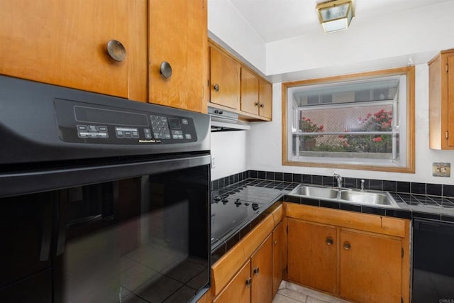 6552 Mallard St, San Diego, CA 92114 - kitchen with a sink, tile countertops, black appliances, under cabinet range hood, and brown cabinets