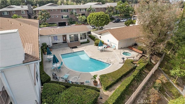 pool with a patio, a residential view, and entry steps