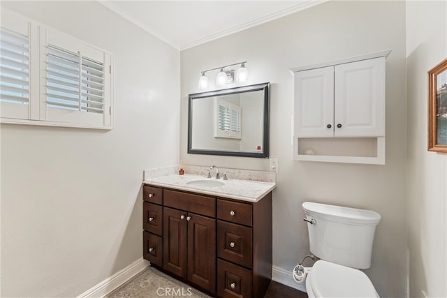 bathroom featuring toilet, baseboards, vanity, and ornamental molding