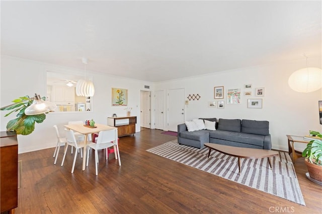 living room featuring wood finished floors and a ceiling fan
