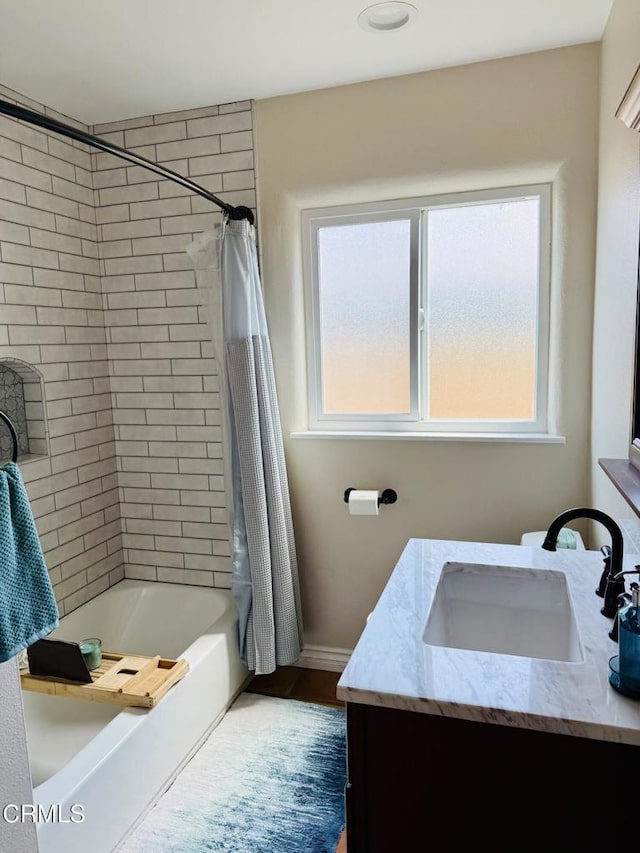 full bath featuring plenty of natural light, baseboards, vanity, and shower / bathtub combination with curtain