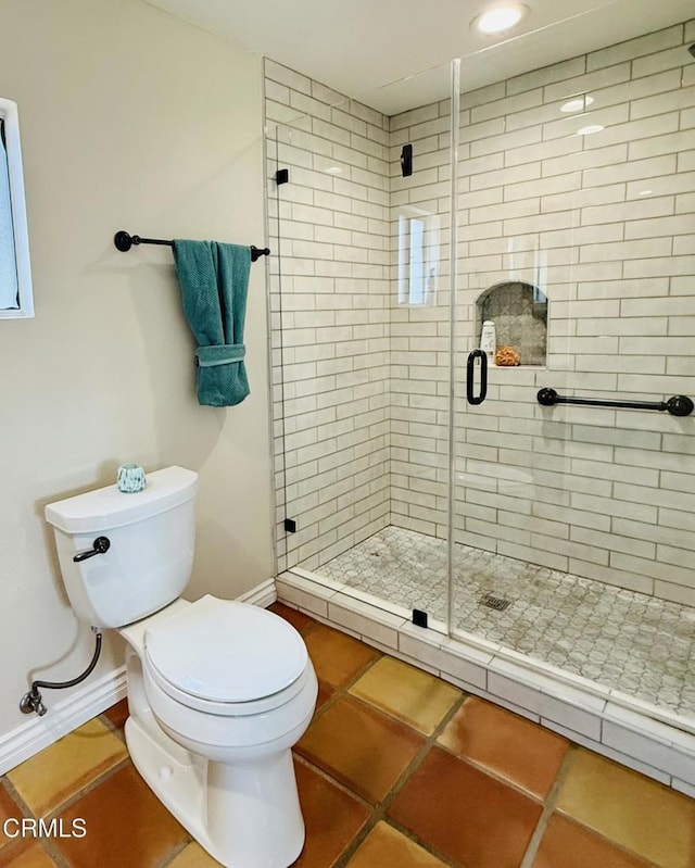 full bathroom with toilet, baseboards, tile patterned floors, and a stall shower