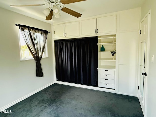 unfurnished bedroom featuring baseboards, a closet, and dark carpet