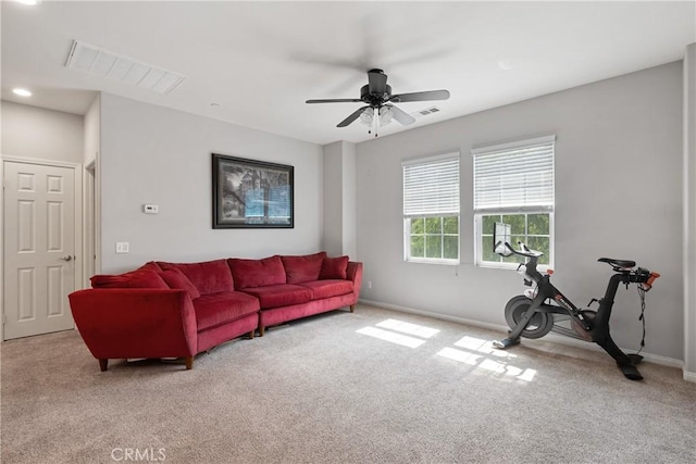 living area with visible vents, baseboards, ceiling fan, and carpet floors
