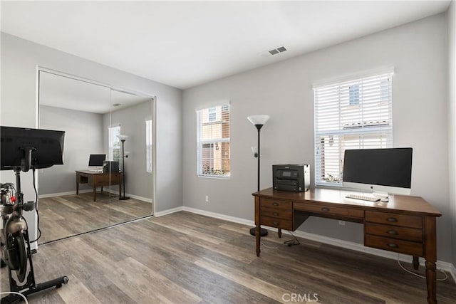 home office featuring baseboards, visible vents, and wood finished floors