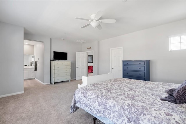 bedroom with a ceiling fan, baseboards, ensuite bathroom, visible vents, and light colored carpet