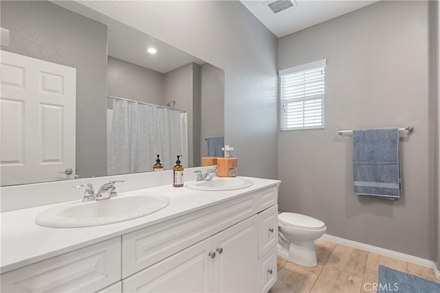 full bath with double vanity, toilet, visible vents, and a sink