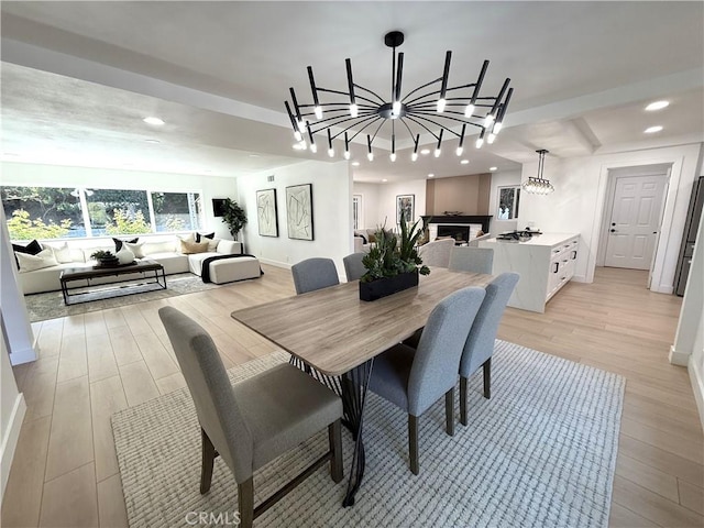 dining room with light wood-type flooring, recessed lighting, a chandelier, and baseboards