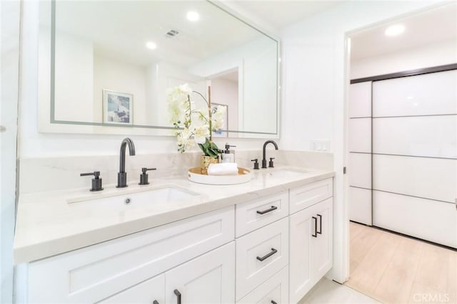 full bathroom featuring double vanity and recessed lighting