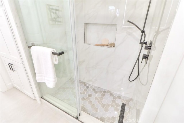 full bathroom with a marble finish shower