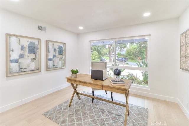 office area with light wood-style floors, baseboards, and recessed lighting
