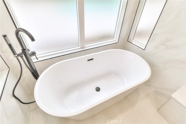 bathroom featuring a freestanding bath