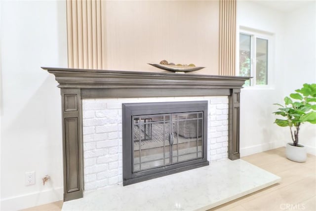 detailed view of a brick fireplace and baseboards