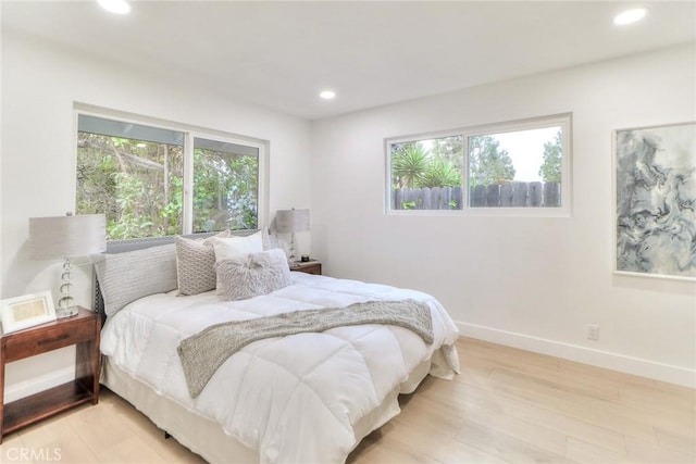 bedroom featuring recessed lighting, wood finished floors, and baseboards
