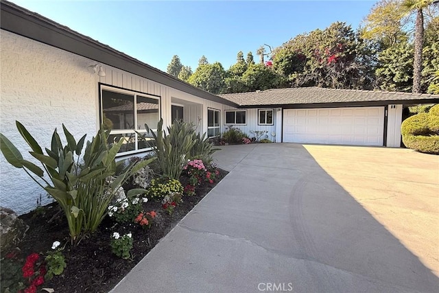 view of front of property with concrete driveway and a garage