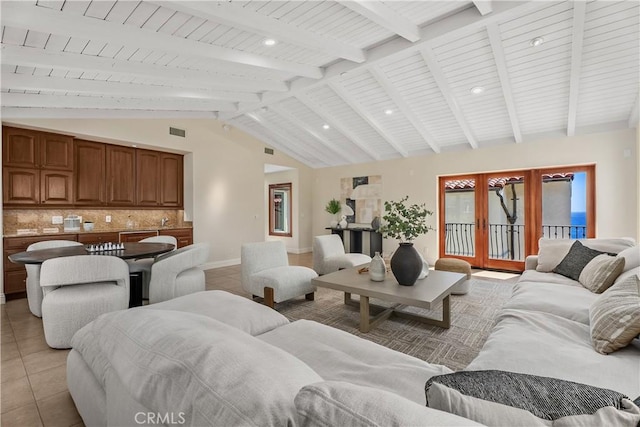 living area featuring french doors, vaulted ceiling with beams, visible vents, baseboards, and light tile patterned flooring