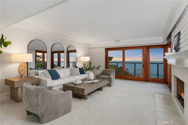 35451 Camino Capistrano, Dana Point, CA 92624 - carpeted living room with a brick fireplace, crown molding, and a water view