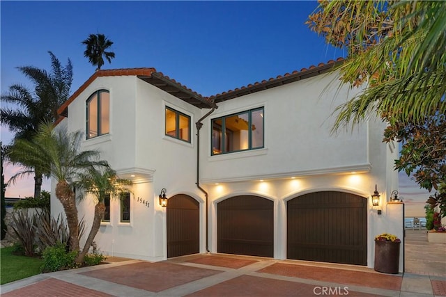 35451 Camino Capistrano, Dana Point, CA 92624 - mediterranean / spanish-style house with stucco siding, a garage, and decorative driveway