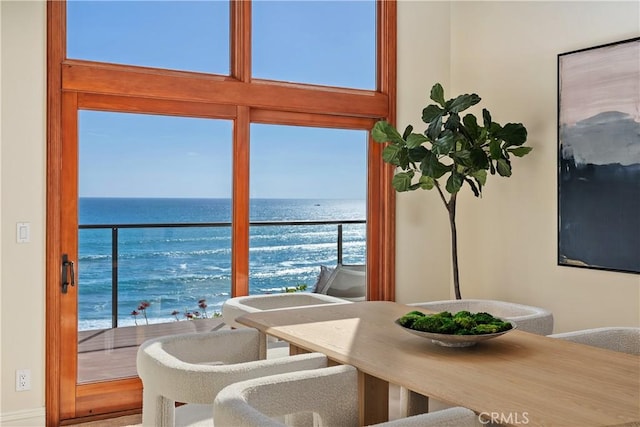 dining space with a water view and a healthy amount of sunlight