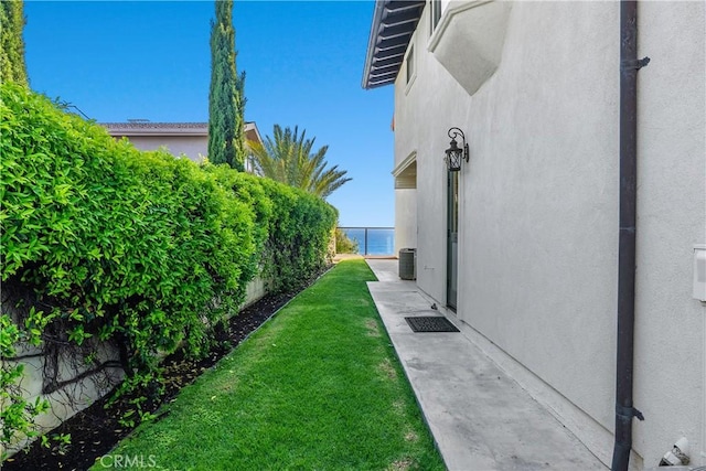 view of yard featuring fence and a water view
