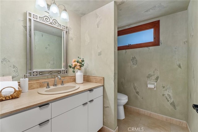 bathroom featuring toilet, baseboards, tile patterned flooring, and vanity