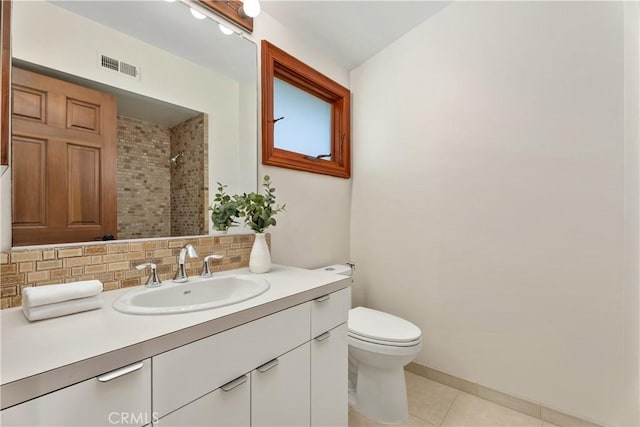 full bathroom with vanity, visible vents, tile patterned floors, backsplash, and a tile shower