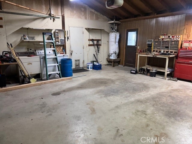 14122 Pawnee Rd, Apple Valley, CA 92307 - garage featuring a workshop area, a garage door opener, and wood walls
