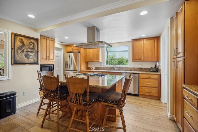 11300 Dulcet Ave, Porter Ranch, CA 91326 - kitchen featuring stainless steel appliances, range hood, a breakfast bar area, light stone counters, and light wood-type flooring