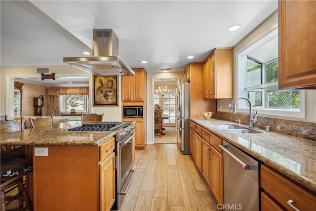 11300 Dulcet Ave, Porter Ranch, CA 91326 - kitchen with stainless steel appliances, island exhaust hood, healthy amount of natural light, a kitchen breakfast bar, and recessed lighting
