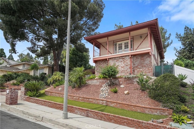 11300 Dulcet Ave, Porter Ranch, CA 91326 - view of front of home featuring brick siding and a balcony
